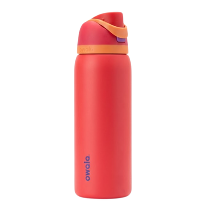 Botella térmica Owala FreeSip de 24 onzas en color coral (Shy Guy). La tapa multicolor presenta colores coral y beige . Cuerpo de acero inoxidable con aislamiento al vacío para bebidas heladas.